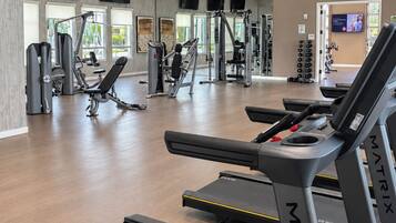 A gym with treadmills, weight machines, and exercise equipment.