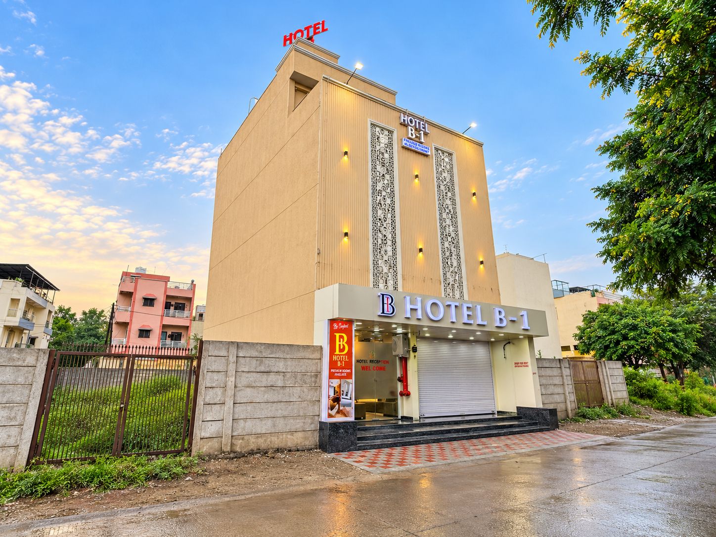 A hotel with a reception area, a closed entrance, and a gated driveway.