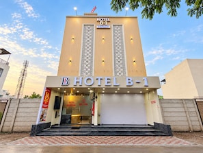 A hotel building with a sign indicating 'HOTEL B-1' and 'PREMIUM ROOMS & RESTAURANT'. - Hotel B-1 (Indore)