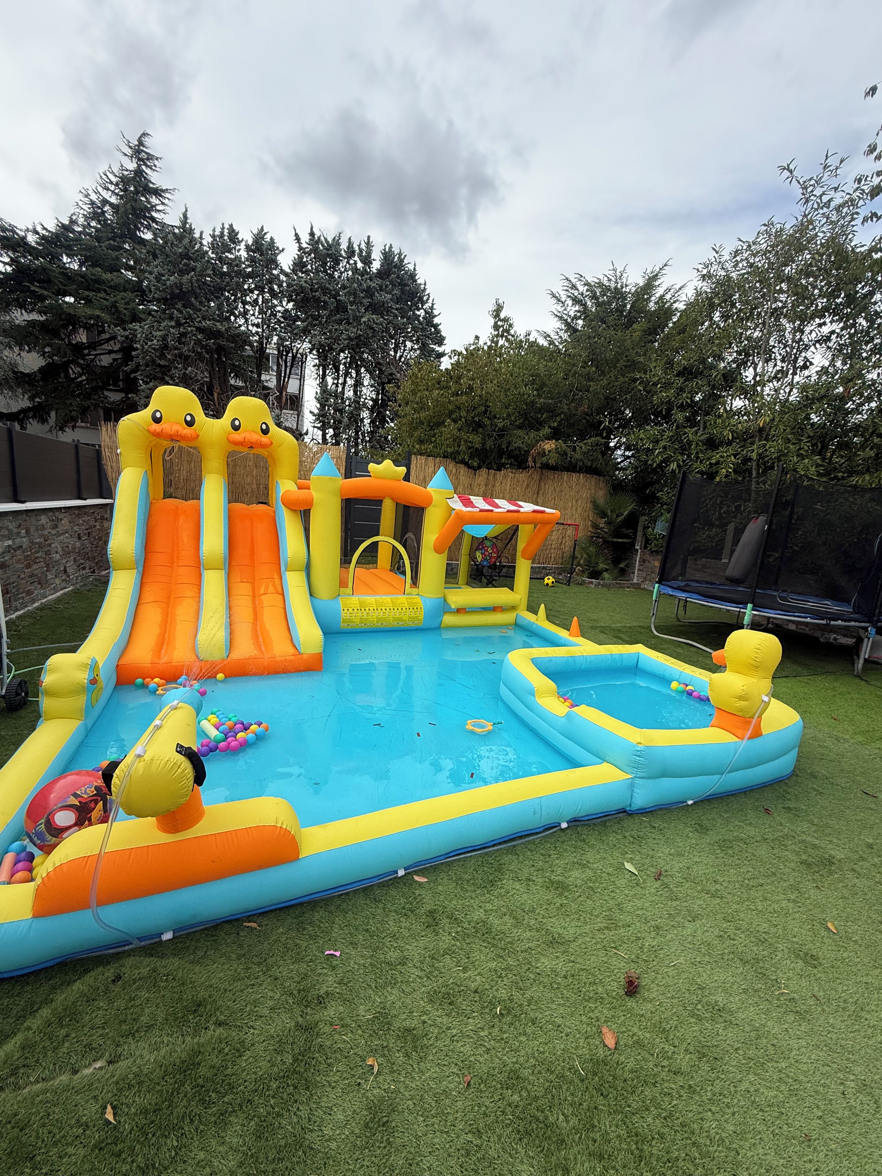 An inflatable play area with slides, a small pool, and a ball pit.