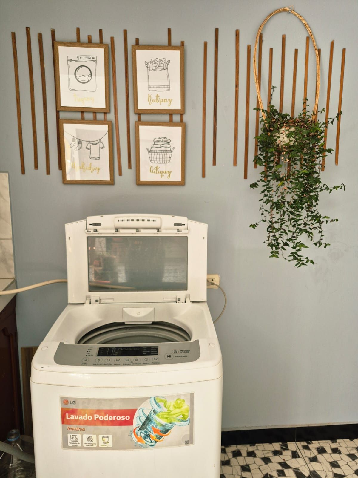A front-loading washing machine with a control panel and a label.