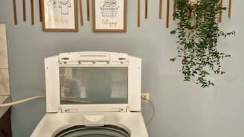 A front-loading washing machine with a control panel and a label.