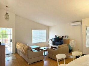 A compact living space with a sofa, a television, a fan, and a small table. - 3b2b single story house in beautiful Chino with New kitchen/Ping-Pong table/WIFI (Chino)