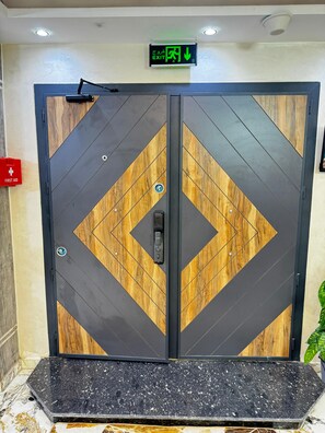 A double door with a first aid sign, an exit sign, and a security keypad. - The "Villa of Dreams VIP" is reserved exclusively for families. The renter is required to provide a security deposit, which will be refunded upon checkout. (Giza Governorate)
