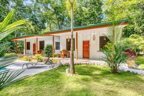 A two-story house with a covered patio, a swimming pool, and lush greenery. - Haze Villa | Tropical Retreat & Pool (Puerto Viejo De Talamanca)