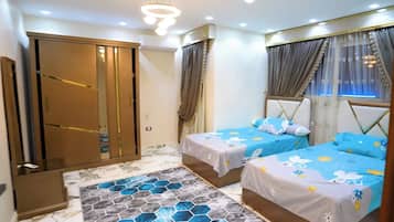 A bedroom with two beds, a wardrobe, and a patterned floor.
