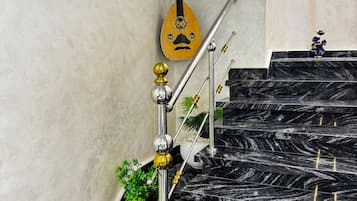 A staircase with black marble steps and a handrail with decorative elements.