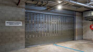 A garage door with a sign indicating resident's car park units 2 to 20.