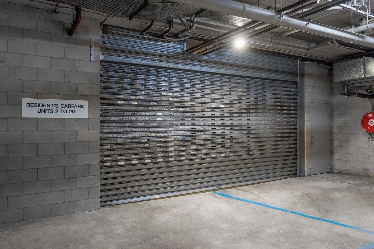 A garage door with a sign indicating resident's car park units 2 to 20.