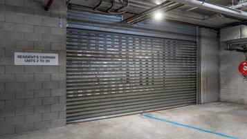 A garage door with a sign indicating resident's car park units 2 to 20.