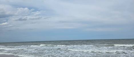 A beach with waves approaching the shore.