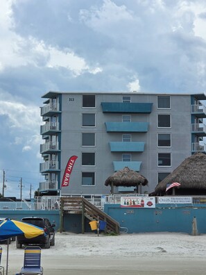 A multi-story building with balconies, a staircase, and a beachside location. - Oceanfront Paradise at Fountain Beach Resort in gorgeous Daytona Beach (Daytona Beach Shores)