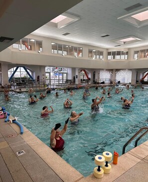 An indoor swimming pool with multiple lanes and a diving platform. - Sunshine Sanctuary - Peace, Quiet & Sunshine - 55+ Active Senior Community (Sun City)