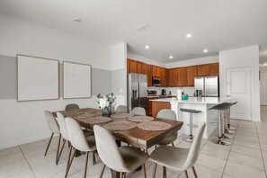 An inviting dining setup positioned perfectly for shared family meals - Designer Home with Private Pool and Disney Access (Kissimmee)