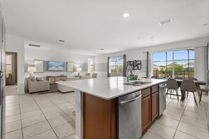 Spacious open layout connecting the main living and dining areas seamlessly - Designer Home with Private Pool and Disney Access (Kissimmee)