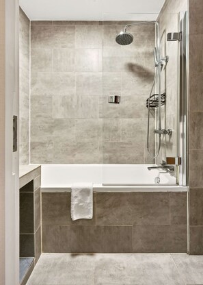 A modern bathroom with a shower, a bathtub, and a towel rack. - Covent Garden Studio · Sleeps 3 · Floral St (London)