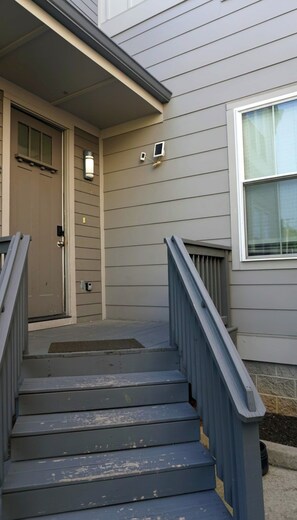 A residential staircase leading to a front door with a mailbox and a small outdoor light fixture. - Sleeps 10, free parking — Hart Suites #4 (Nashville)