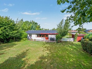 A house with a red roof, a covered patio, and a lawn. - "Mea" - 750m from the sea by Interhome (Væggerløse)