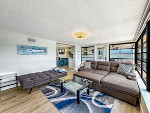 A modern living room with a sofa, a glass coffee table, and a rug. - Pool & Hot Tub! Waterfront+Close To Beach! (Pompano Beach)