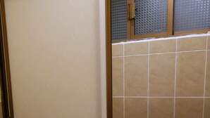 Ein Badezimmer mit Toilette, Waschbecken und Duschbereich.