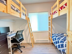A room with bunk beds, a desk with a computer, and a window with blinds. - Boat Launch Access | FirePit | 30MI to YNP (Island Park)