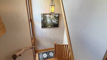 A wooden staircase with a wooden handrail and a wooden floor.