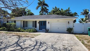 A single-story house with a garage, a front porch, and a driveway. - Naples Inn & Docks (Naples)