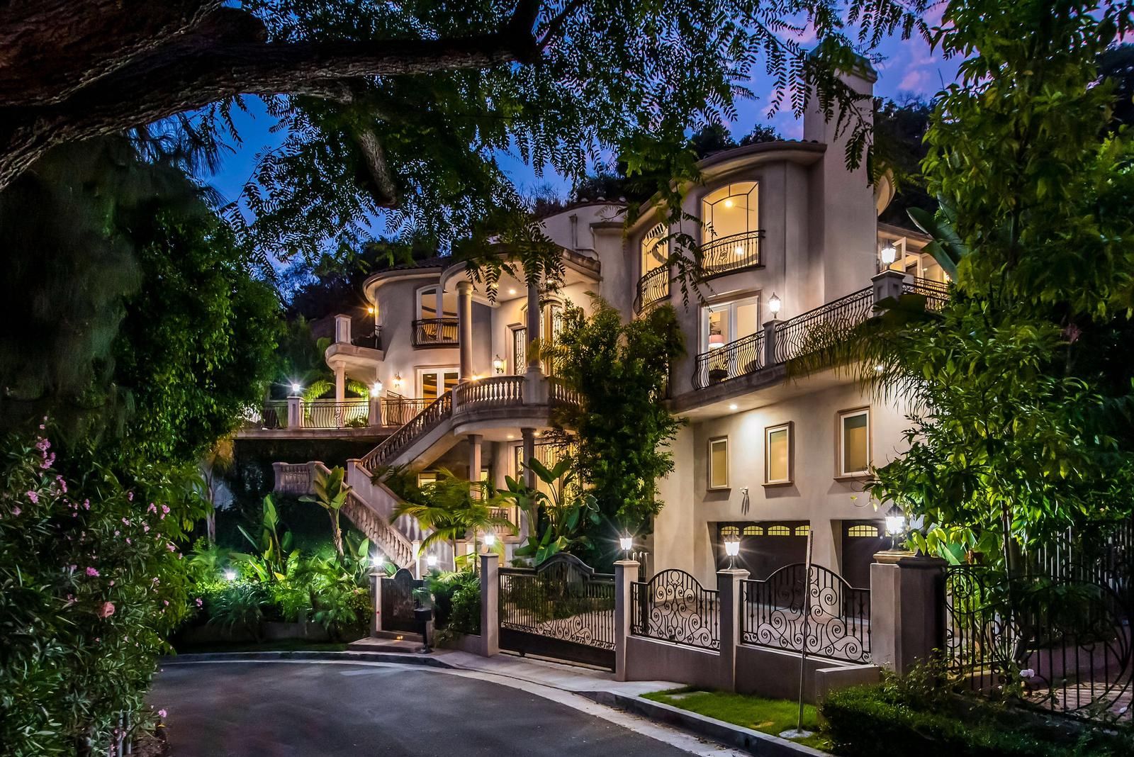 A multi-story building with a grand entrance, a staircase, and a well-lit facade.