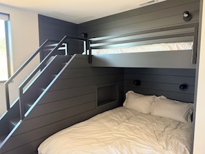 A bunk bed with a built-in ladder and a small window. - Luxury Skyridge home - sleeps 12 - large game room (Daniel)
