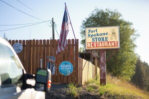 A wooden fence with a sign for Fort Spokane Store Restaurant.