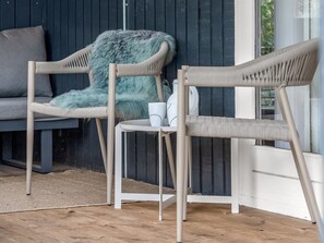 Two wicker chairs with a small table and a fluffy throw blanket against a dark wooden wall. - "Dirtje" - 850m from the sea by Interhome (Ebeltoft)
