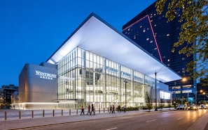 A modern building with a glass facade and a prominent 'Wintrust Arena' sign.