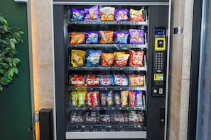 A vending machine stocked with various snacks and candies.
