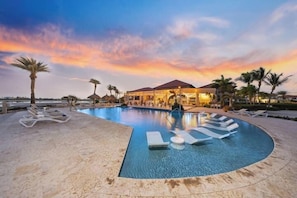A pool area with lounge chairs and a sunset view. - Villa Diamante: Luxe Oasis, Gold Coast 4BR 3BA (Noord)