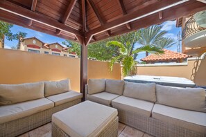 An outdoor seating area with wicker furniture and a pergola overhead. - 4BR Townhome-Private Hot Tub & Gazebo w/ Pool, Gym (Noord)