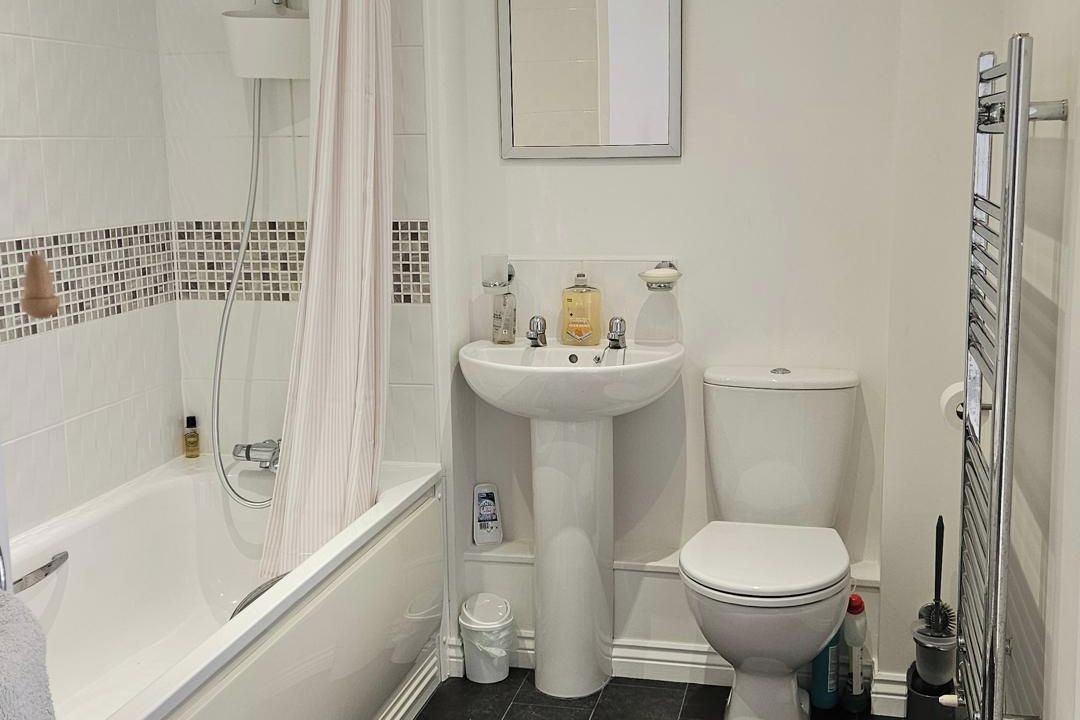A bathroom with a bathtub, a sink, and a toilet.