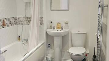 A bathroom with a bathtub, a sink, and a toilet.