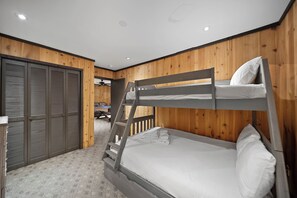 A bunk bed with a ladder, a wooden wardrobe, and a ceiling with recessed lighting. - Beech Mountain Cabin with Retro Mountain Charm (Beech Mountain)