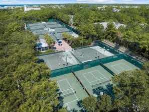 An aerial view of a tennis court complex surrounded by dense forest. - Phase 1 WaterColor, EZ Walk to Beach Club! 2 Bikes (Santa Rosa Beach)