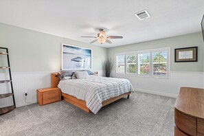 A bedroom with a bed, a ceiling fan, a window with blinds, and a framed certificate on the wall. - Waterfront 4BR + deep water+ 2 Docks + Outdoor Kitchen, Sleeps 11 (Ruskin)