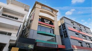 A hotel with a modern facade, featuring a prominent sign with the name "HOTELO" and a tagline. The building has multiple floors with balconies and large windows. - Hotel O Cooch Behar (Cooch Behar)