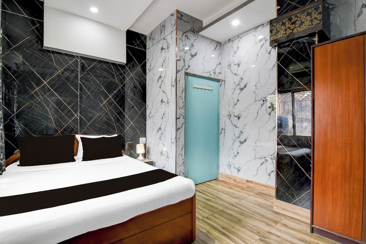 A modern bedroom with a bed, a wardrobe, and a door.