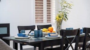 A dining table set with plates, bowls, and a vase with flowers. - Spacious Family Home with Multiple Living Areas (Baulkham Hills)