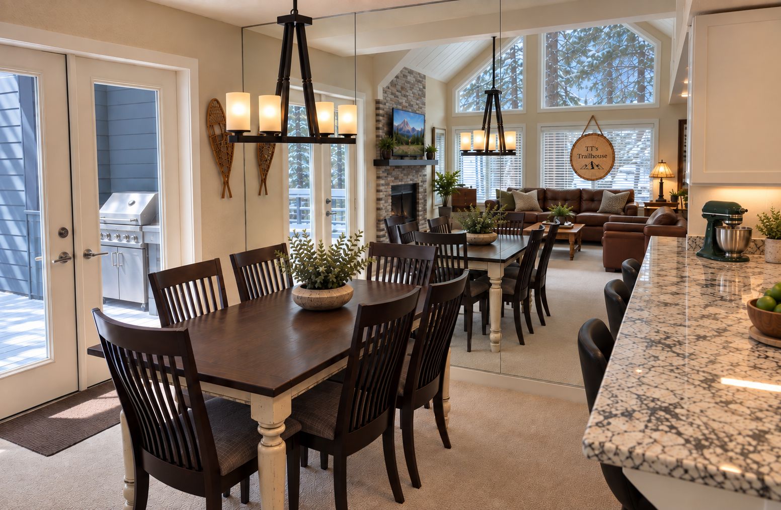 A spacious kitchen with a dining area, large windows, and a fireplace.