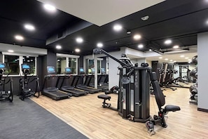 A gym with treadmills, weight machines, and exercise equipment. - Lux Living 3BD 3BTH in K-Town, Pool, Gym & Parking (Los Angeles)