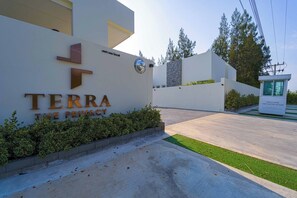 A sign for 'TERRA THE PRIVACY' with a modern design, a welcoming message, and a small kiosk in the background. - 3BR Luxury Pool Villa, Hua Hin (TP3) (Hua Hin)