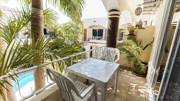 Standard Quadruple Room, Pool View | Outdoor dining