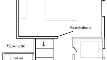 A floor plan with a kitchen, living area, master bedroom, ensuite bathroom, and WC.