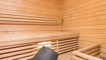 A sauna with wooden slats and a black chair.