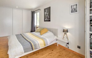 A bedroom with a bed, bedside lamps, a wardrobe, and a picture on the wall. - Stunning home in Espeluche with private swimming pool, can be inside or outside (Espeluche)